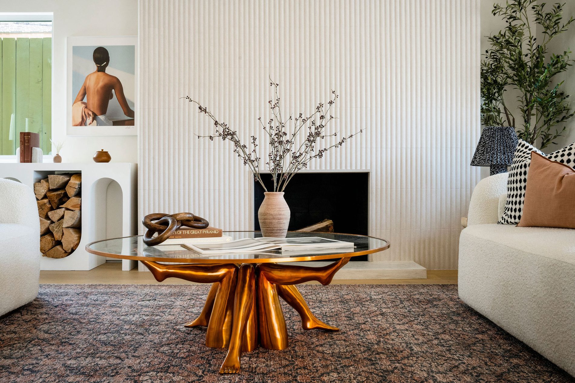 A living room with a sculptural coffee table and layered textures.